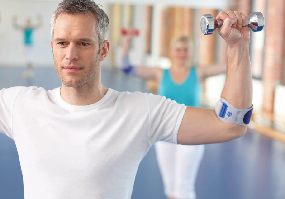 Man doing elbow strengthening exercise in an EpiPoint Elbow Strap
