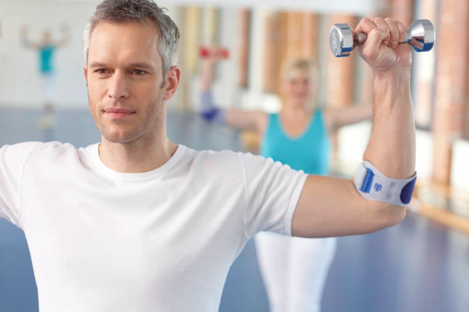 Man doing elbow strengthening exercise in an EpiPoint Elbow Strap