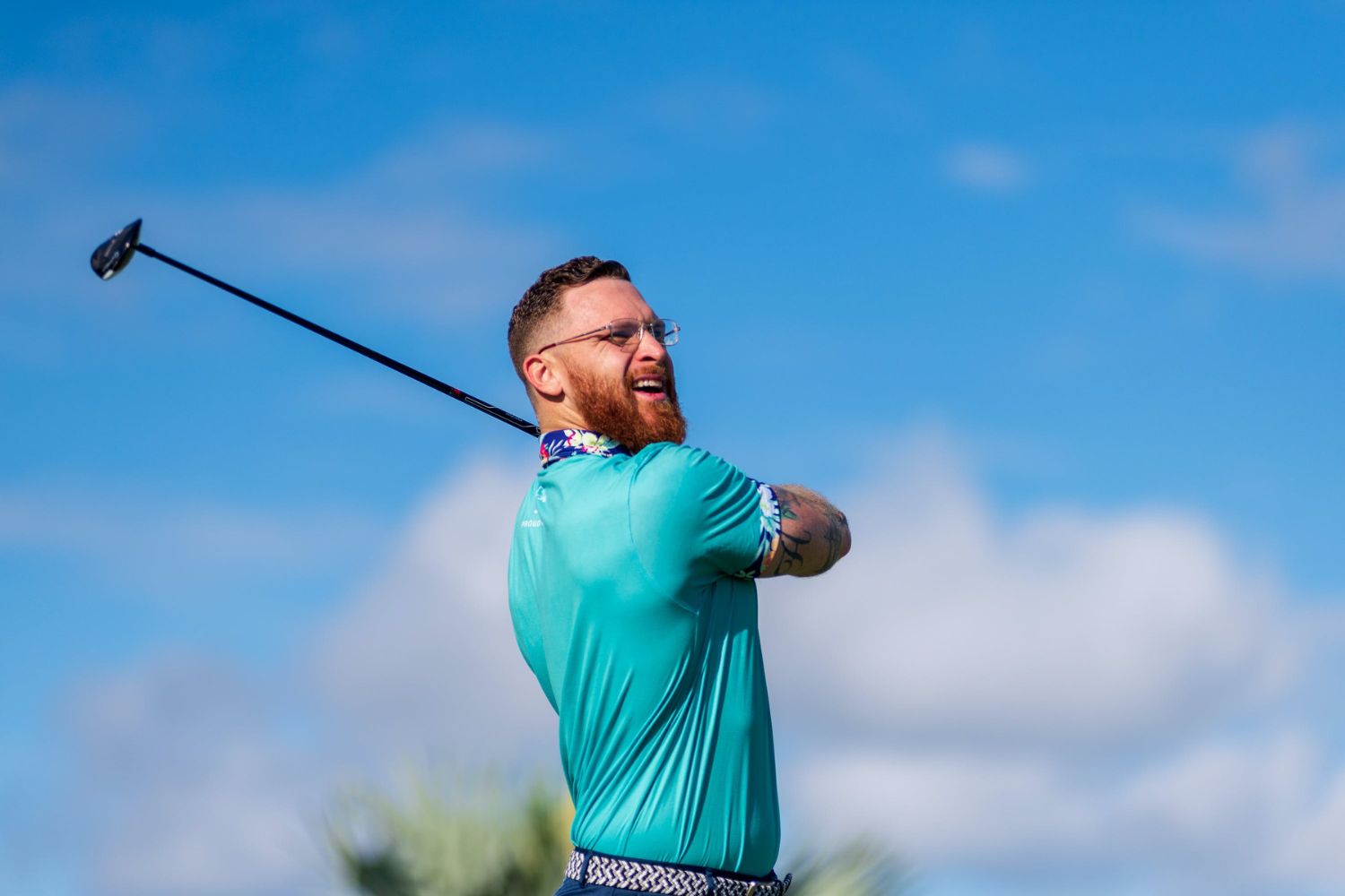 man in the follow through of a golf swing