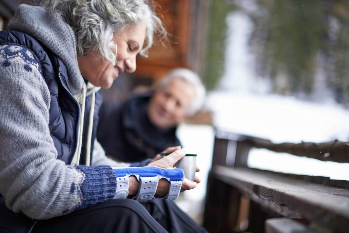 Woman drinking coffee in a ManuLoc Wrist Brace to relieve wrist arthritis pain