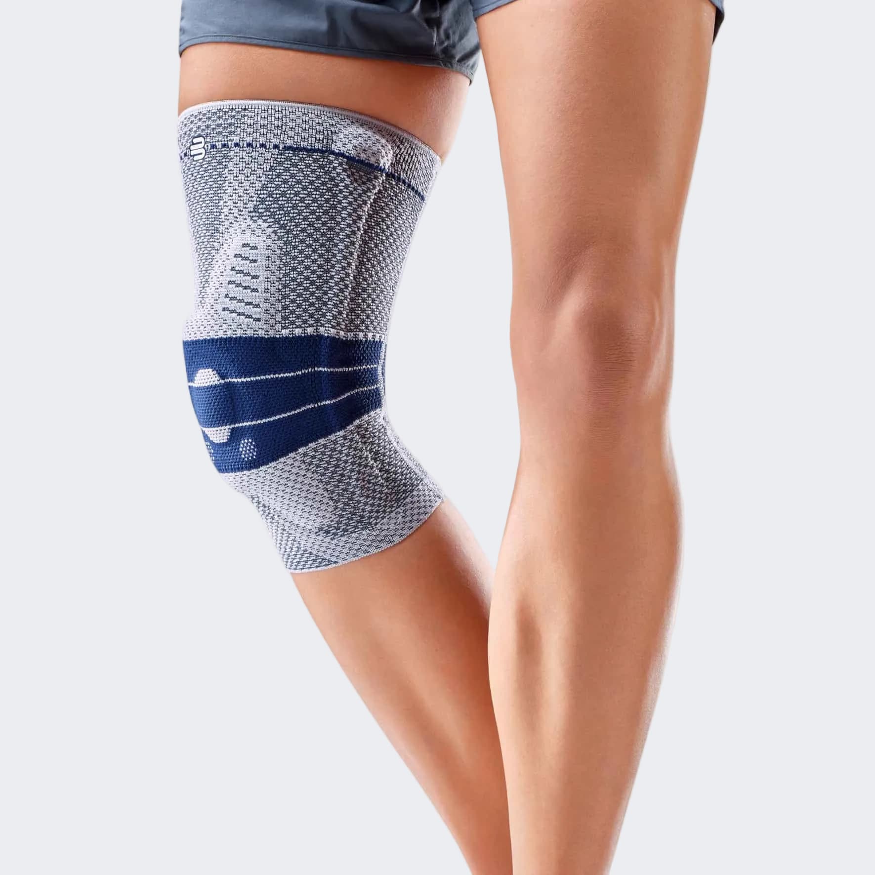GenuTrain A3 knee brace on a person's leg with a grey background