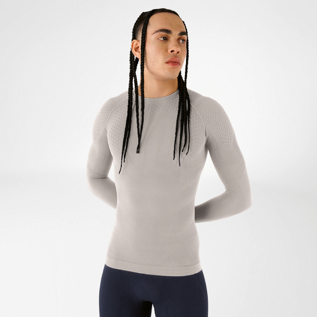 Person wearing a grey Bauerfeind compression long-sleeve shirt against a white background