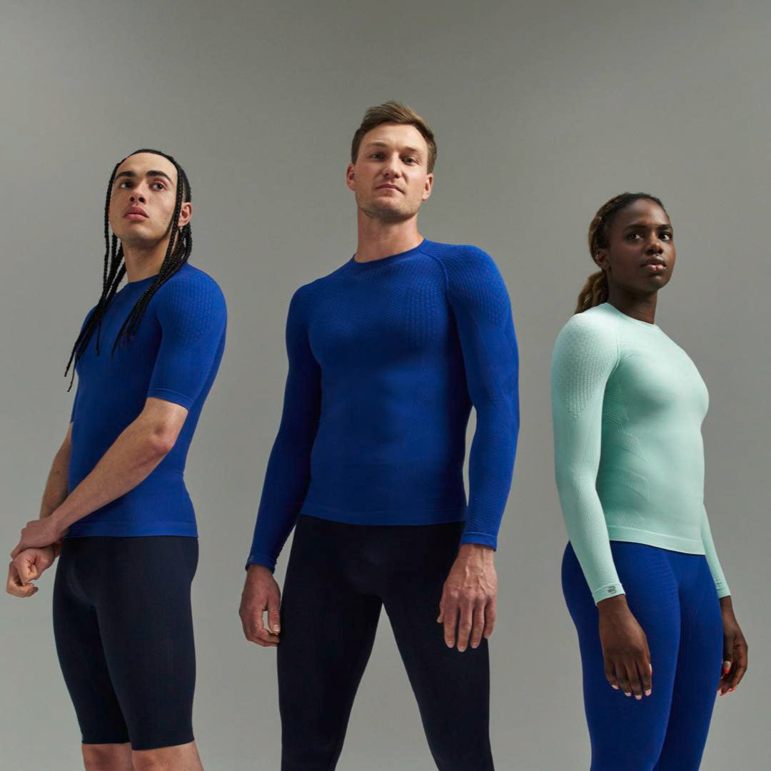Three people wearing Bauerfeind Compression wear against a gray background