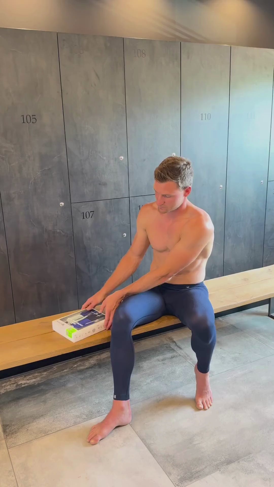 a video of a man showing how to put a Bauerfeind Sports Compression Shirt on