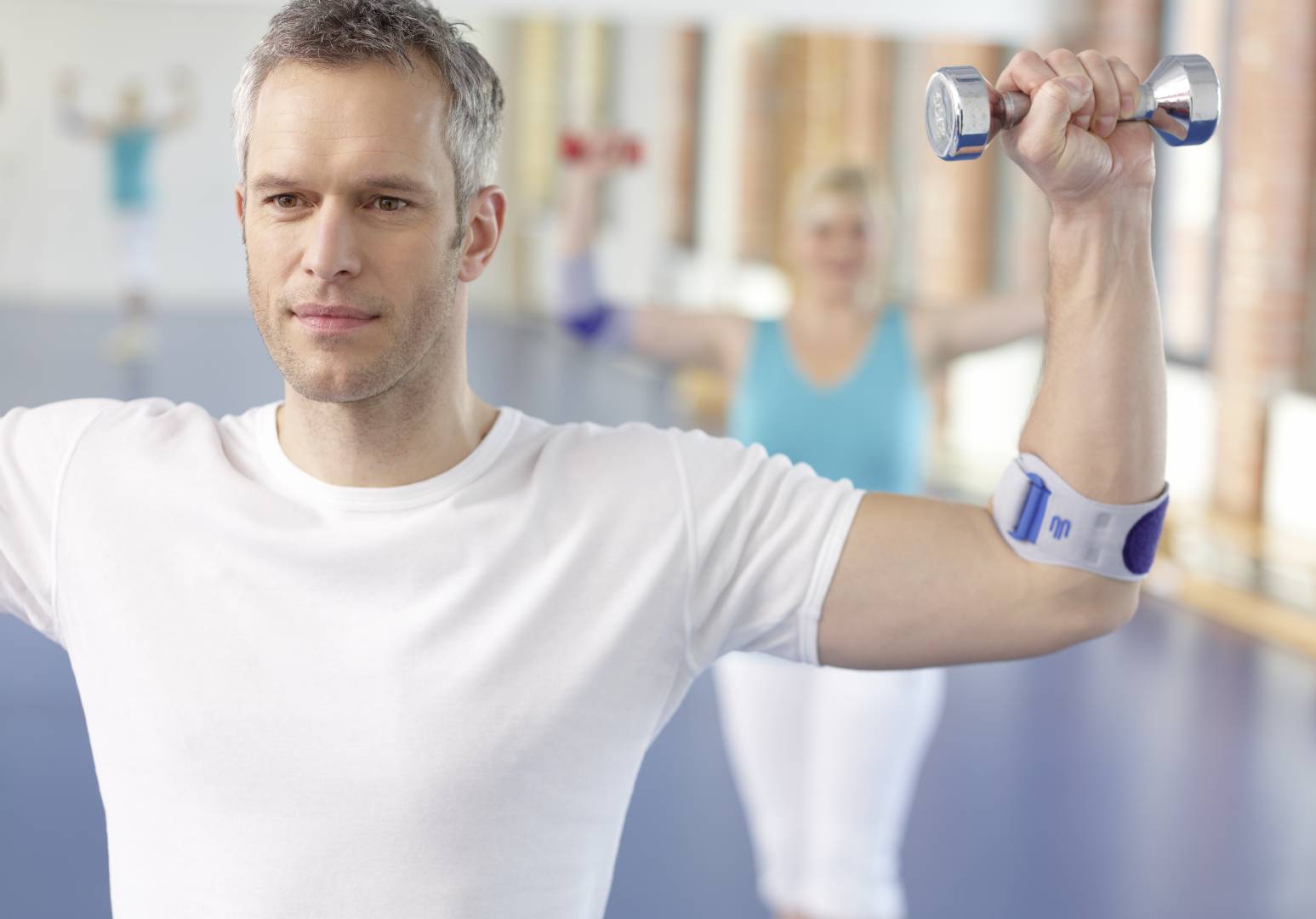 Man doing elbow strengthening exercise in an EpiPoint Elbow Strap