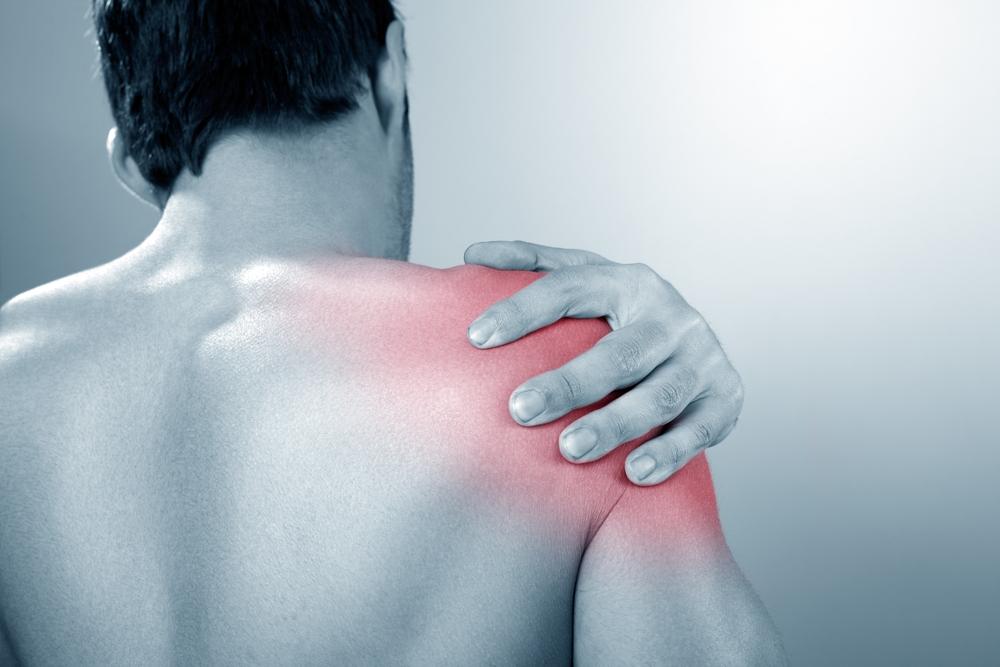 Image of man holding injured shoulder