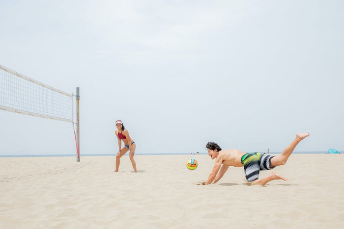 People playing beach volleyball