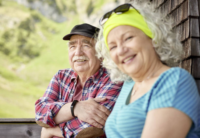 Male and female smiling together outside