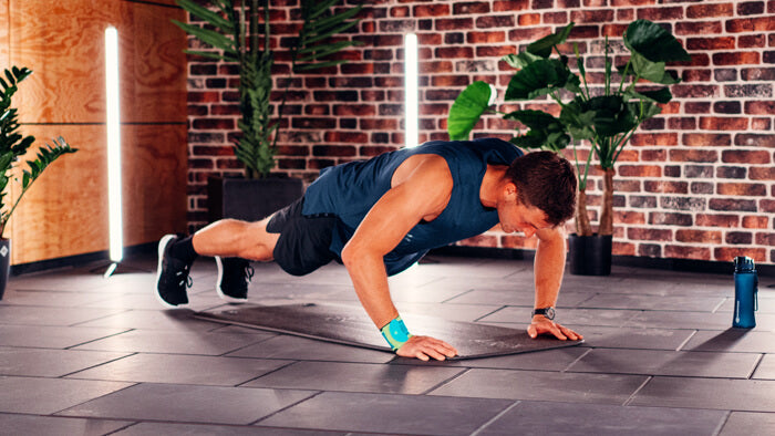 Thomas Roehler performing burpees while wearing Bauerfeind's Sports Wrist Strap