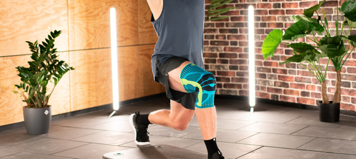 Thomas performing the lunge and twist exercise while wearing Bauerfeind's Sports Knee Brace