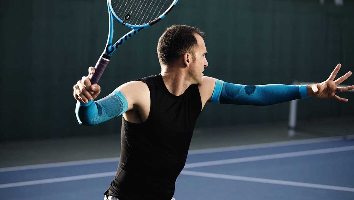 Man playing tennis wear compression sleeves for sports recovery