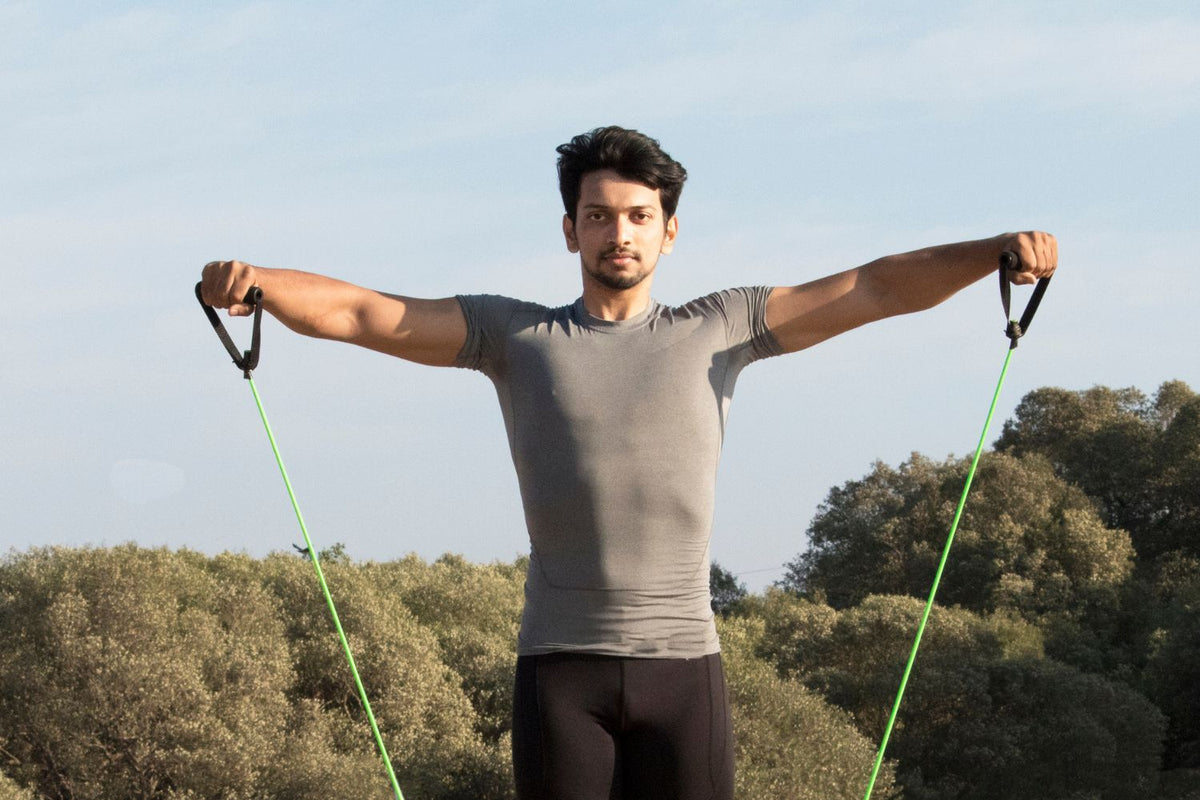 Man doing Resisted Shoulder Abduction exercise at the park