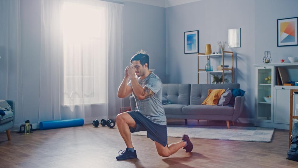 Man doing lunges in his living room