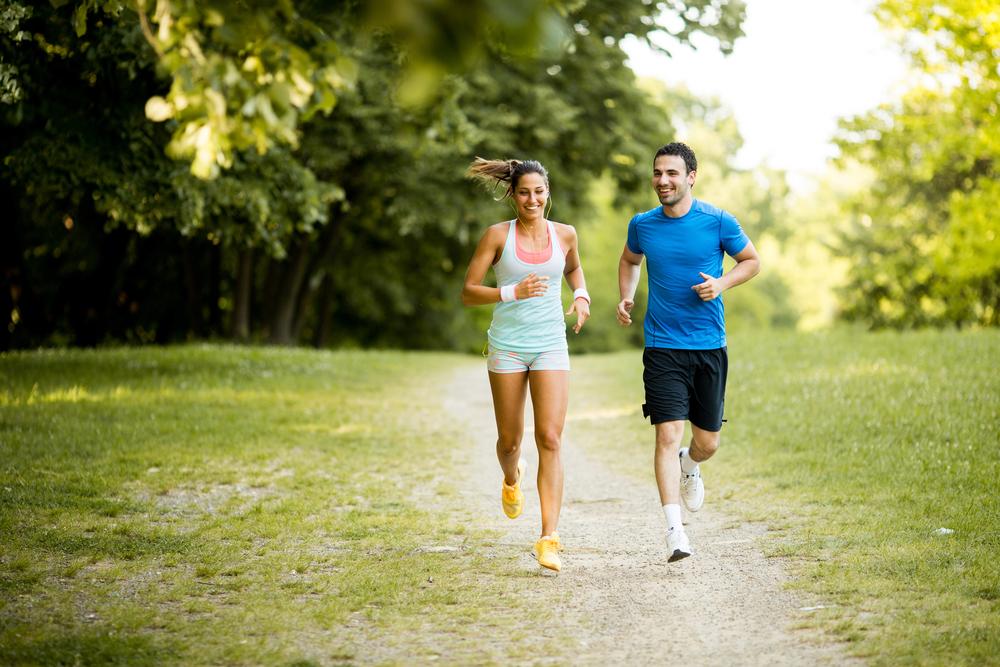Young couple running. Running on Grass vs Concrete: Does it matter?