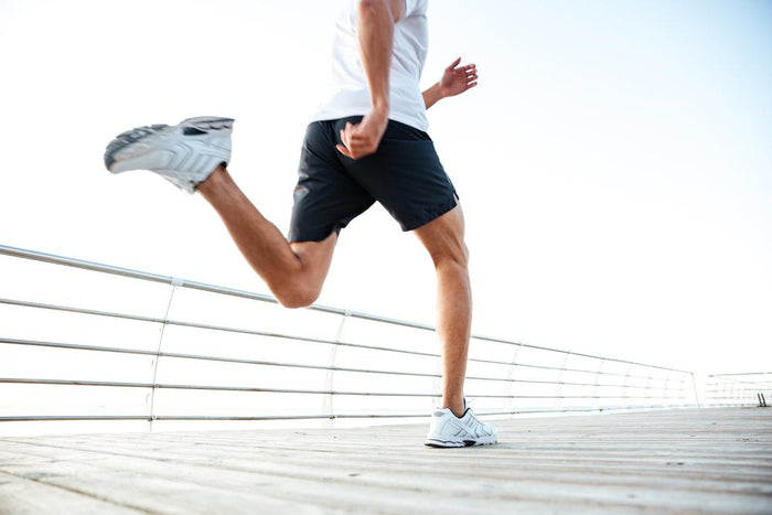 Man running along boardwalk related to blog on how long should you wait to run after a torn ACL injury