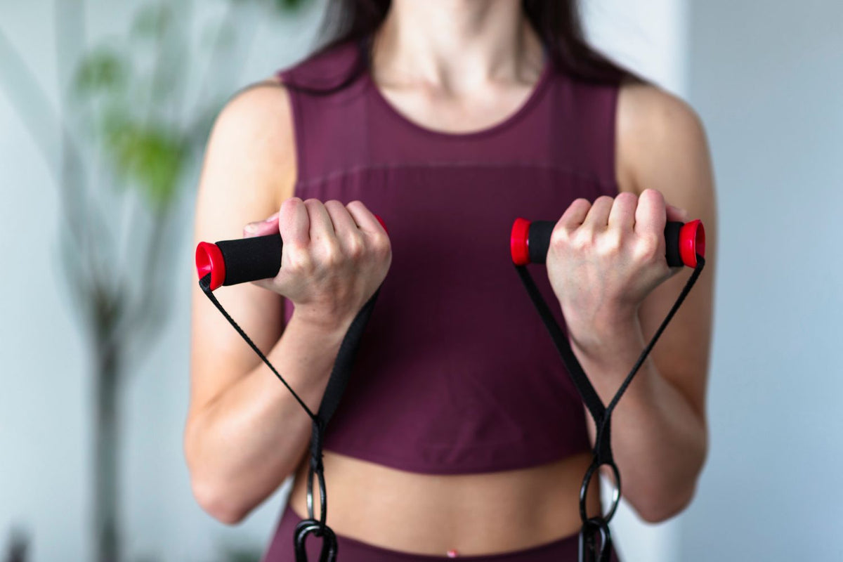 Woman preparing to do the standing rows exercise with resistance bands