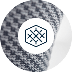 Hexagonal logo of Bauerfeinds active knit on a grey and blue knitted fabric background.