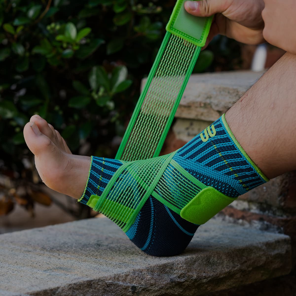 A close up shot of someone putting on a Bauerfeind Sports Ankle Support