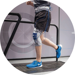 Person using a treadmill wearing a GenuTrain S hinged knee brace during a scientific test.